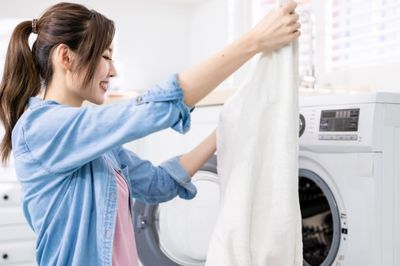 women washing clothes in washing machine