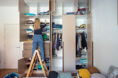 women cleaning closet with white vinegar