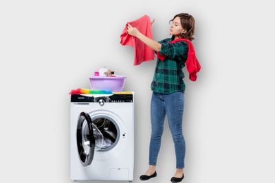 girl washing clothes in washing machine