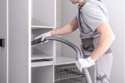 man vacuuming closet