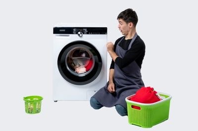 man cleaning clothes in washing machine