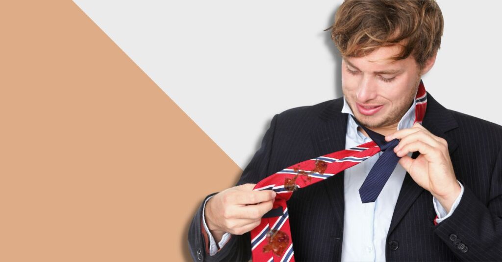 man removing stained tie