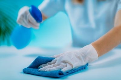 women applying disinfectant spray