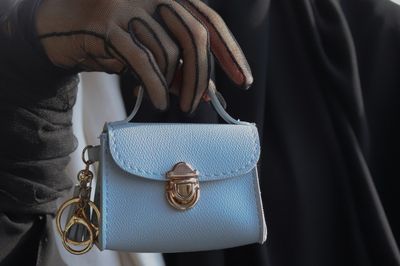 women holding small white leather purse