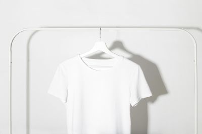 white t-shirt hanging on hanger 