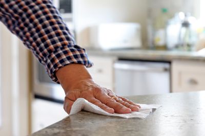 man cleaning kitchen countertop