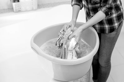 women hand washing vintage clothes