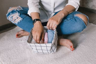 women storing clothes in container